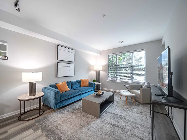 a spacious living room with a large window at Harbor Pointe, Bayonne, New Jersey