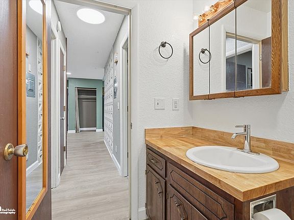 Bathroom, view looking back down hallway to living room area.