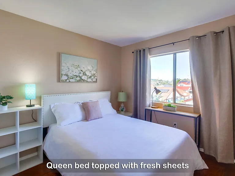 Wake up to a bright and refreshing morning on your cozy queen bed in Bedroom 2