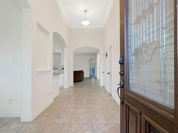 Gorgeous wood lead glass front door.. Grand entrance, powder room and coat closet are located on the right side walking into the property pass the study