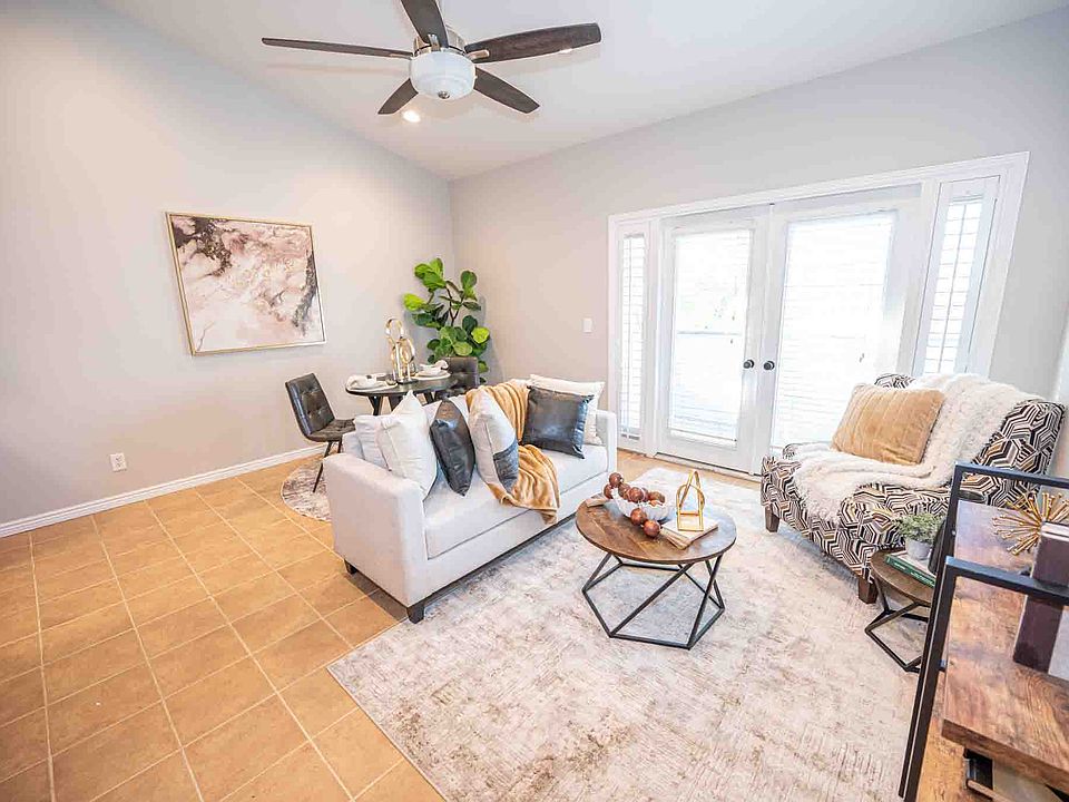 Living area with vaulted ceilings and balcony.