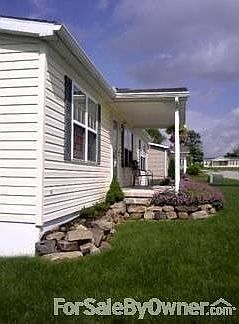 Front of house
						:
						front porch and rock landscaped ledge