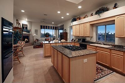Spacious island kitchen with beautiful custom cabinetry and granite tops.