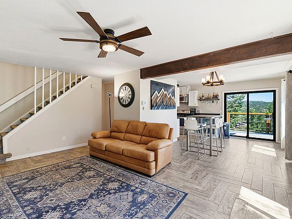 Open-concept living with mountain views, luxury flooring, and plenty of room to host guests. The elevated dining area is perfect for meals, game nights, or working from home.