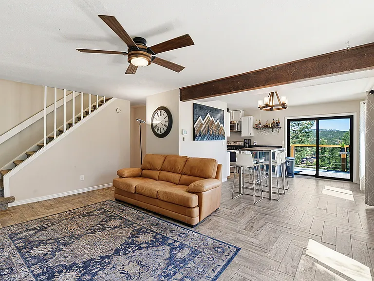 Open-concept living with mountain views, luxury flooring, and plenty of room to host guests. The elevated dining area is perfect for meals, game nights, or working from home.