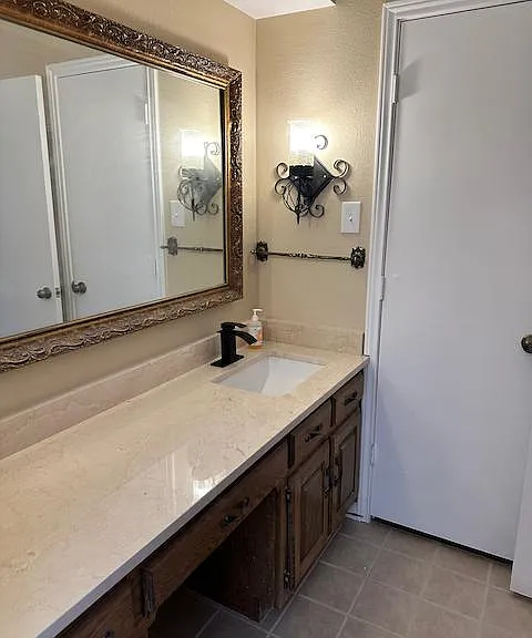 First vanity (of two) in master suite features new granite countertop and sink and fixture and ready access to walk-in closet