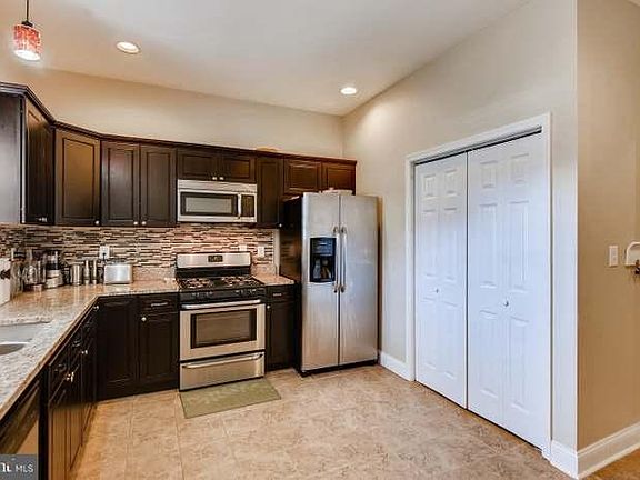 First floor: Kitchen opens up to a deck and concrete backyard