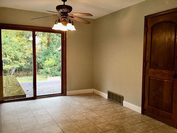Dining area with new patio door leads out to deck and private wooded lot