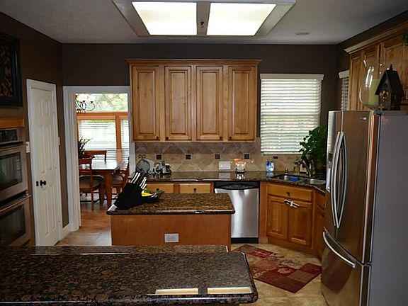 kitchen features a granite island with breakfast bar seating.