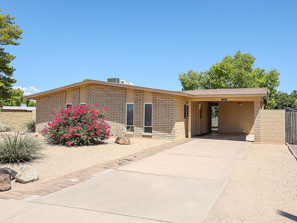Front of house showing driveway and car port. Solar lighting is included. Kitchen door can be opened with a fingerprint.