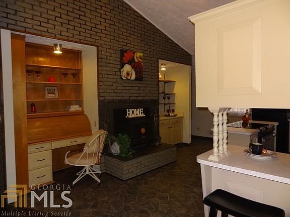 Built in roll top desk. Wood burning stove with convection oven in masonry double sided fireplace