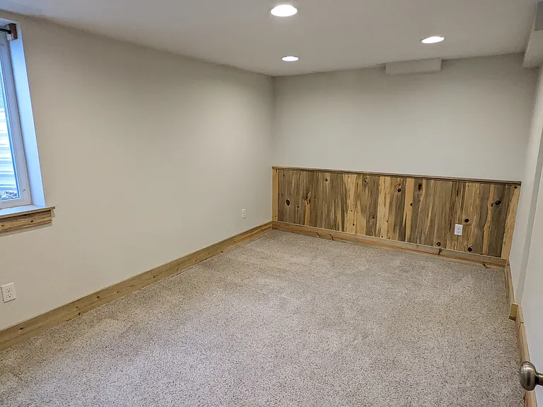 Custom Wainscotting in Basement Bedroom with Tons of Natural Light