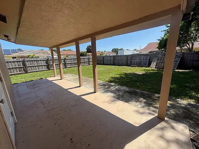 View from Cover patio to large fenced-in yard