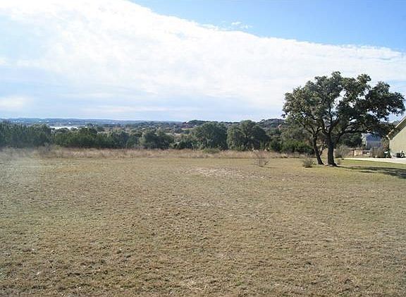 View of lot and lake with neighbor's house to the right.