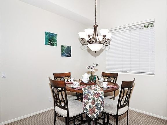 A closer look at the formal dining room with beautiful chandelier.