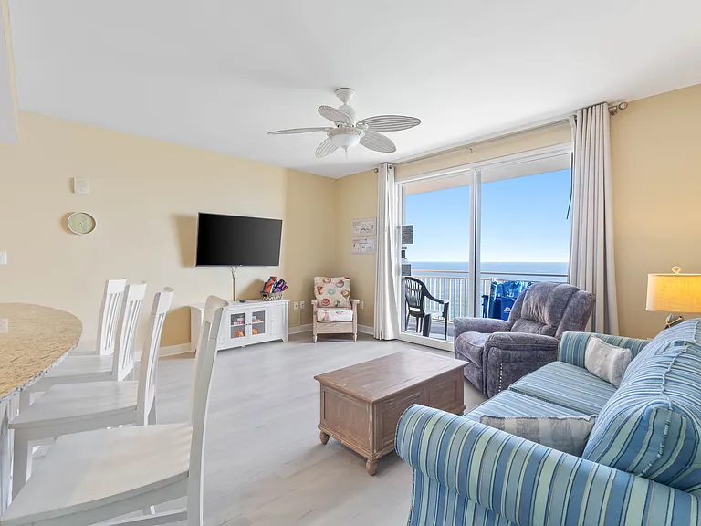 The living room connects to a balcony offering gorgeous views of the coast