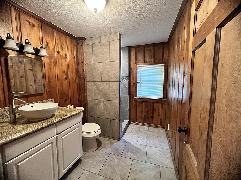 upstairs bathroom with tile shower