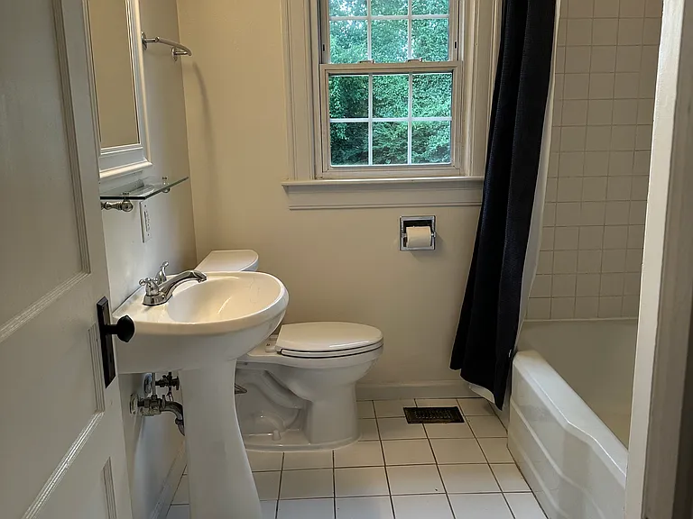 Bathroom complete with linen closet behind entrance door (left)