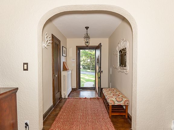 Please come in and visit for a while . . . the welcoming entrance foyer greets you and you immediately sense the fine details of a classic Tudor. Please note the traditional archway, pristine wood floors and gently stuccoed walls. 