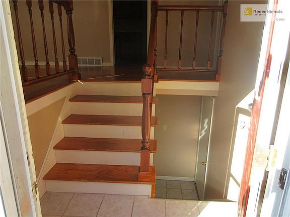Gleaming entry with original hardwood stair treads and newer ceramic tile is very welcoming!