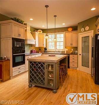Gorgeous kitchen with maple flooring, highend cabinetry, walkin pantry.