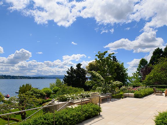 French doors from nearly every room lead to an expansive limestone terrace overlooking the rose garden, specimen trees and level lawn.