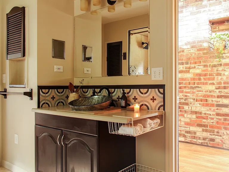 Beautiful newly remodeled bathroom with retro backsplash and Japanese-inspired glass wash basin