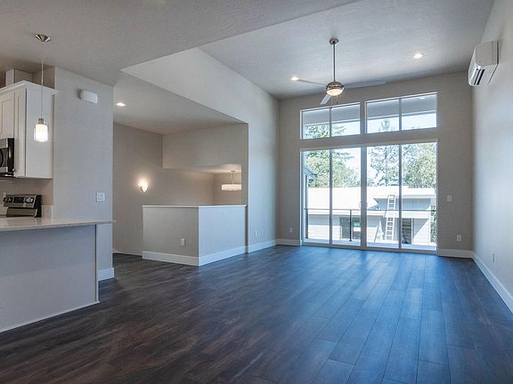 Open great room with 12' ceiling. Converging sliding glass doors open to expansive views from the covered balcony