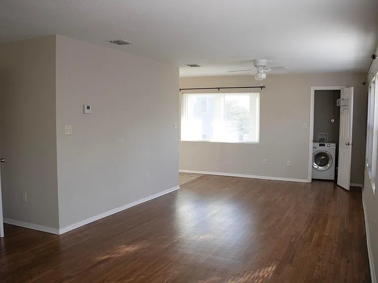 view from back of main living space, front closet with washer/drier combo