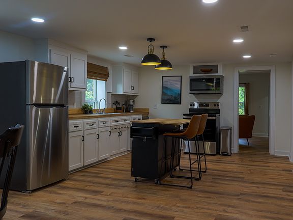 Kitchen with island and brand new appliances incl dishwasher, fridge, freezer, oven/stove