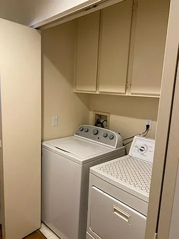 Full size washer and dryer in the hallway to guest bath