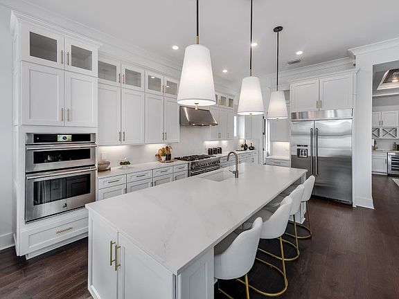 Thoughtfully designed kitchen with built-in appliances cabinets and oversized island