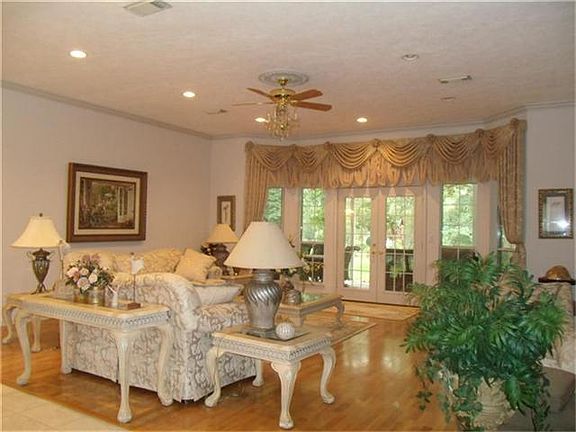 Formal living room with 10' ceilings, crown molding and atrium door to patio.