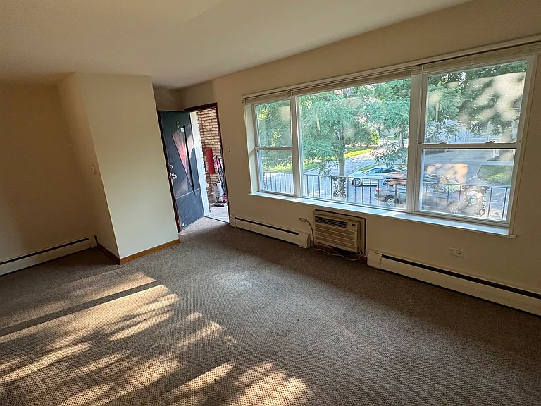 living room facing the front windows and the front door