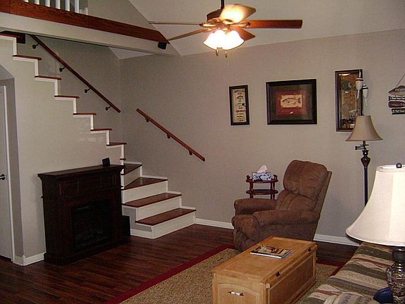 Another view of living with electric fire place and stairs to loft.