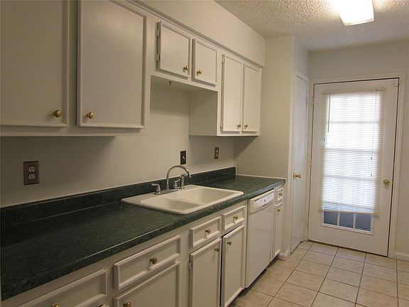 Recently painted kitchen is nice and bright with access to the balcony overlooking the complex.