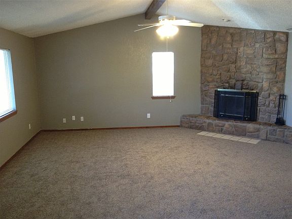 Vaulted ceiling with beam, stone fireplace