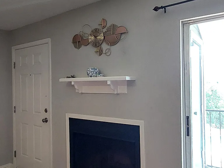 Entry door, fireplace and balcony door