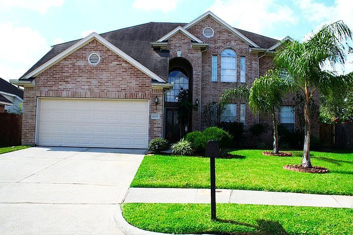 Luscious Green Front Yard with Palm Trees