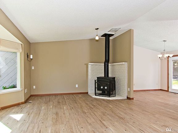 Bright and sunny great room with new flooring, paint & millwork. Vaulted ceilings in this efficiently designed rambler.