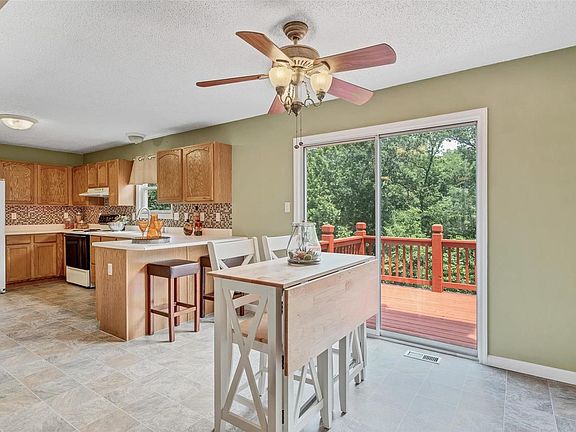 Breakfast room open to kitchen has gorgeous view of woods.