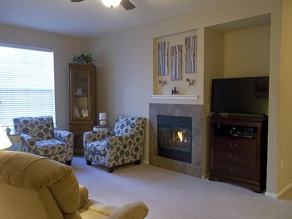 Cozy living room with gas fireplace and 40 inch TV and dual VCR/DVD player.