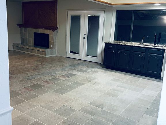 The kitchen opens up to the den or the living room.