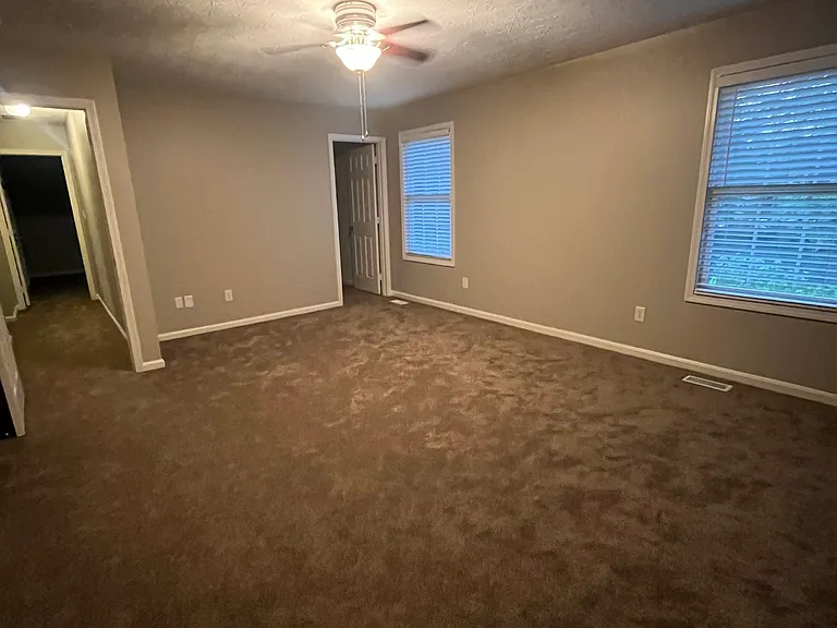 Primary bedroom with new carpet and TWO walk in closets