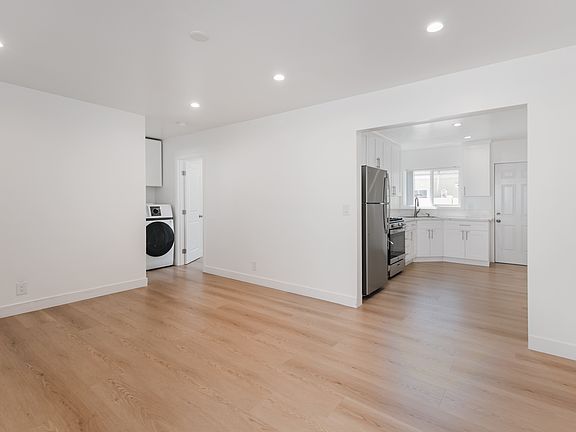Living Room with Recessed Lighting Leading into the kitchen