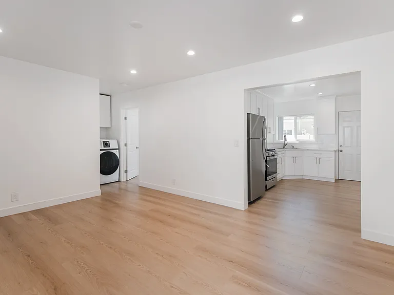 Living Room with Recessed Lighting Leading into the kitchen