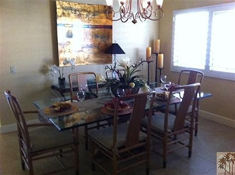 Formal dining room area with lots of light and room have guests.  High ceilings and designer ($2K) chandelier accents this room.