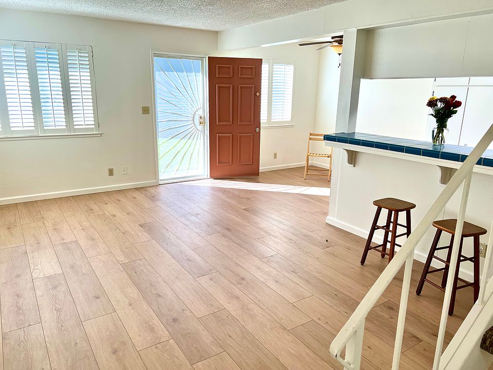 A view towards the security front screen door showing the sun pouring in.