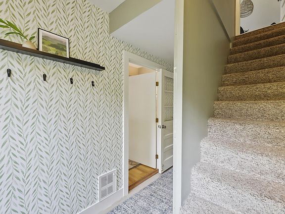 Front Entry, view in to bedrooms and stairs to Great Room- main living area