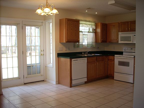Ceramic Tile Floor with Hard Surface CounterTops with French Doors 
